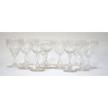 A set of six fortified cut wine glasses of ogee form etched with grape and vine,