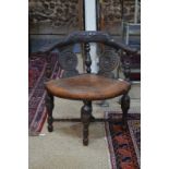 A heavily carved oak corner chair in the Jacobean manner,