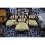 A set of seven mahogany dining chairs in the Sheraton manner with stuff over seats and square