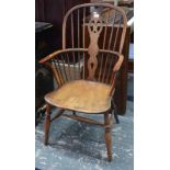 A pair of close matched yew and elm Windsor elbow chairs with hoop backs and fret-cut splats, raised