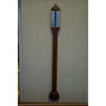 A reproduction walnut stick barometer by Russell of Norwich,