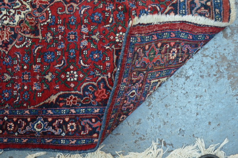A fine Persian Bidjar rug with large central floral motif on red ground within multi-borders, - Image 3 of 3