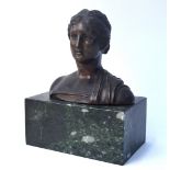 A brown patinated bronze bust of a classical Greek female, unsigned, 14 x 16 cm, on marble clock