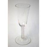 An 18th century ale glass, rounded funnel bowl, multiple spiral opaque twist stem, domed foot and