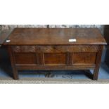 An 18th century panelled oak coffer with later-carved frieze, 115 cm wide