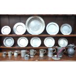 A quantity of antique pewter including; a charger, plates, tankards, jugs, measures, inkwells,