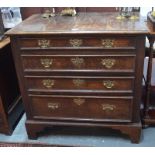 An 18th century oak chest of four long graduated drawers having applied moulded edges and raised on