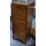 A modern yew veneered and brass-bound chest of two short and five long drawers with sliding shelf