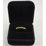 A 9ct yellow gold ring set with four cubic zircona