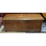 An early 18th century oak coffer with panelled front and sides,