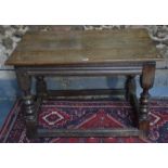 A 17th/18th century jointed oak side table with turned supports united by stretchers