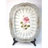 A 19th century Staffordshire meat plate decorated with a shaped pale grey border and painted to the