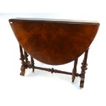 A late Victorian burr walnut Sutherland table with oval top, on turned and spiral fluted supports,