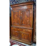 A 19th century provincial French fruitwood buffet a deux corps with twin panelled doors enclosing