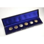 A set of six silver buttons of hammered centres and rope edges in fitted case, maker Samuel Jacob,