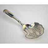 A George III silver fiddle pattern caddy spoon with scalloped bowl and nail-punch decoration,
