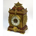 A 19th century French oak mantel clock with ornate brass mounts, J. Marti et Cie movement striking