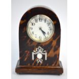 A small tortoiseshell veneered mantel clock with silvered pique-work decoration and enamel dial,