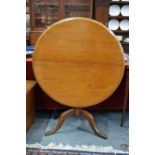 A Victorian mahogany tea table with circular tilt-top, on baluster turned pillar and tripod base,