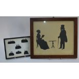 A silhouette cut-out of a Victorian lady and gentleman, 27 x 32 cm, in glazed oak frame,