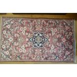 A Persian Mahal with overall floral design on rust field with central blue medallion, 175 x 100 cm