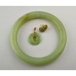 A Chinese green stone bangle to/w pair o