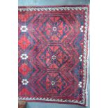 A Persian Balouch rug the red and blue g