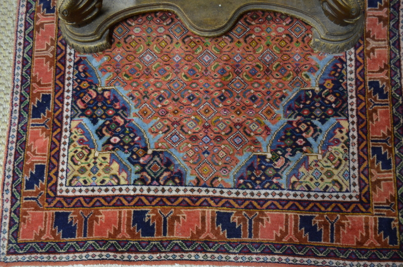 A Persian Ardebil rug, the terracotta gr