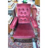 An open armchair with deep button red ve