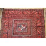 A worn Afghan rug, the central reserve w