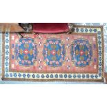 A Turkish rug with triple geometric gul design on pale maroon,