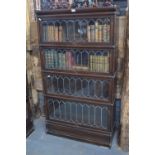 An oak four section Globe Wernicke bookcase with lead glazed doors, raised on a deep plinth base,