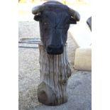 A large bespoke artisan carved green oak garden sculpture of a bull's head raised with patinated