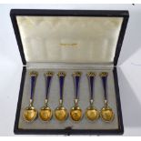 A cased set of six Danish silver gilt and enamel coffee spoons with crown finials,
