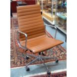 A Charles & Ray Eames EA117 aluminium and dark tan leather chair by ICF (Italy),