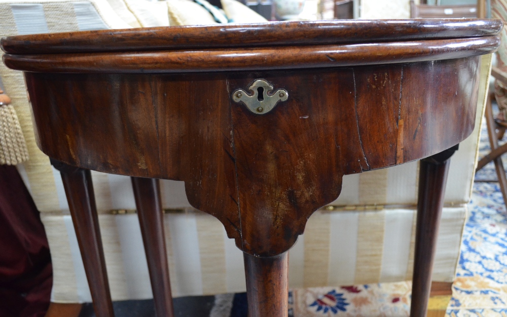 An 18th century mahogany demi-lune fold over gateleg table with storage well raised on four turned - Image 3 of 3