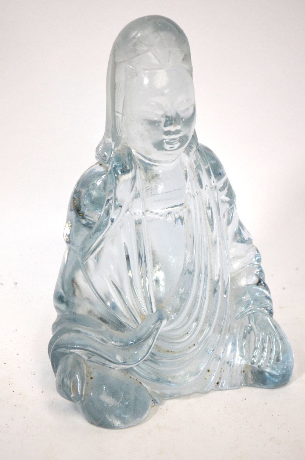 A Chinese translucent glass or crystal figure of Guanyin,