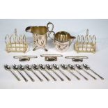 A pair of electroplated toast racks, two cream jugs,