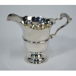 A heavy quality Irish silver helmet cream jug with scroll handle and stemmed foot,
