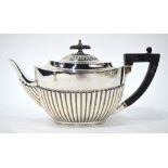 A Victorian oval silver half-reeded teapot with ebony handle and finial, William Hutton & Sons,