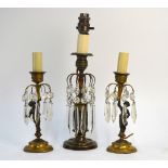 A pair of Regency style parcel gilt bronze lamp-bases with cut glass lustre drops supported by