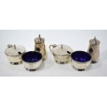 A silver six-piece condiment set with blue glass liners, Walker & Hall,