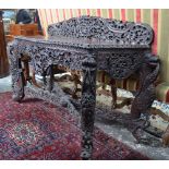 An Anglo-Indian carved hardwood console/side table of serpentine form with a pierced and carved