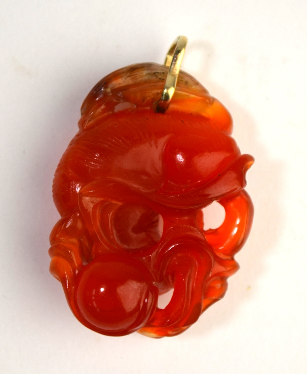 A mottled orange cornelian pendant with yellow metal ring, - Image 2 of 5