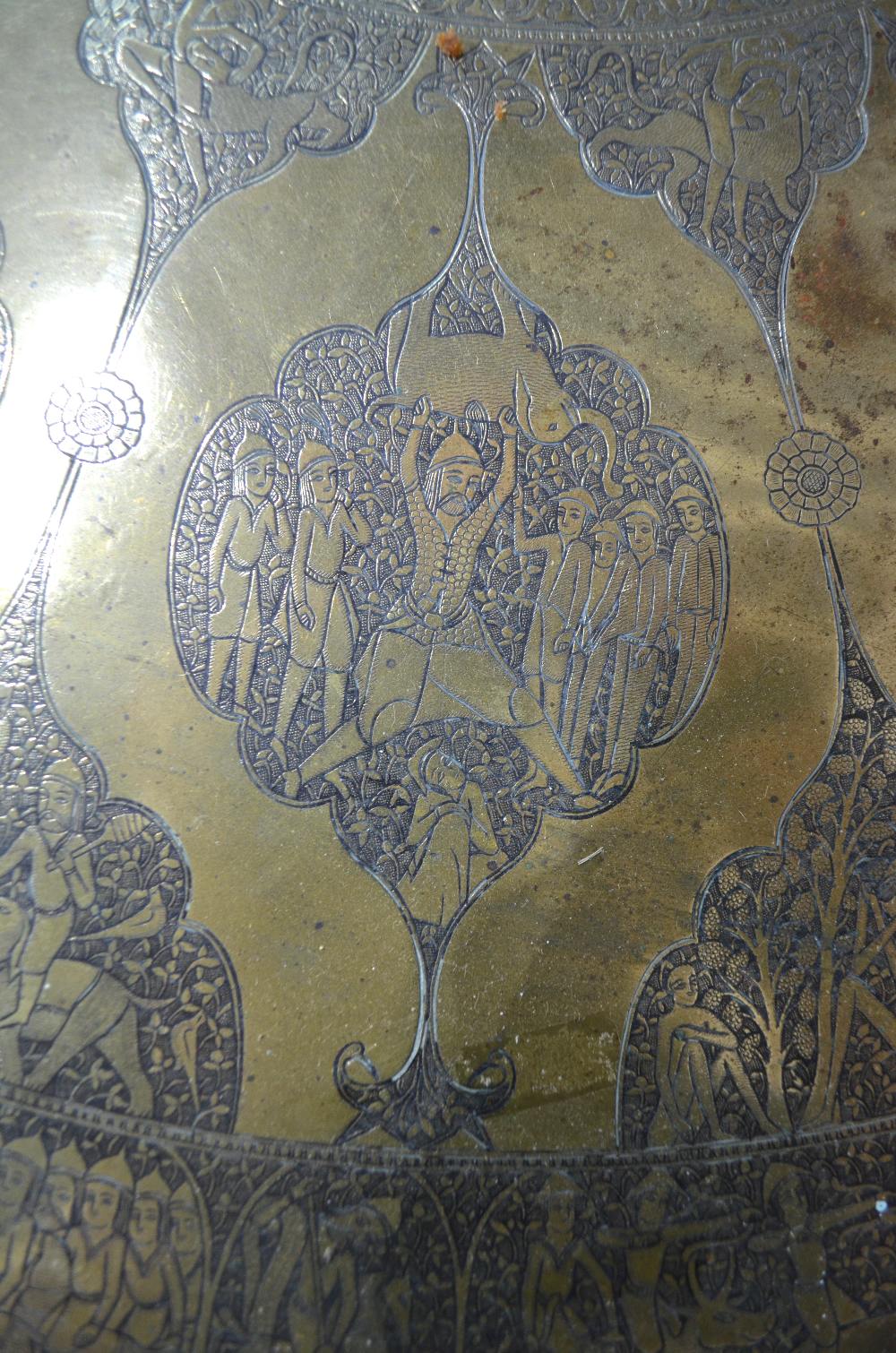 A finely engraved Asian brass tray with pictorial scenes raised on a fruitwood tripod base as a - Image 3 of 6