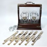A tantalus with electroplated mounts, fitted with two cut and moulded glass square decanters,