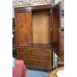 An early 20th century crossbanded mahogany linen press having a pair of panelled doors enclosing a