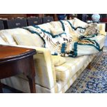 A large country house sofa in the Knowle manner having hinged shaped arms, for re-upholstery,