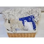 A box and a lined wicker hamper containing table linen to include;