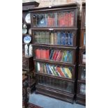 An oak five section Globe Wernicke bookcase with lead glazed doors, raised on a deep plinth base,